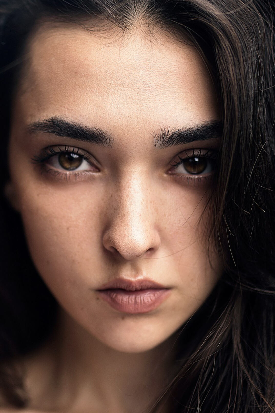 Studio portrait of a young Hispanic woman with dark hair