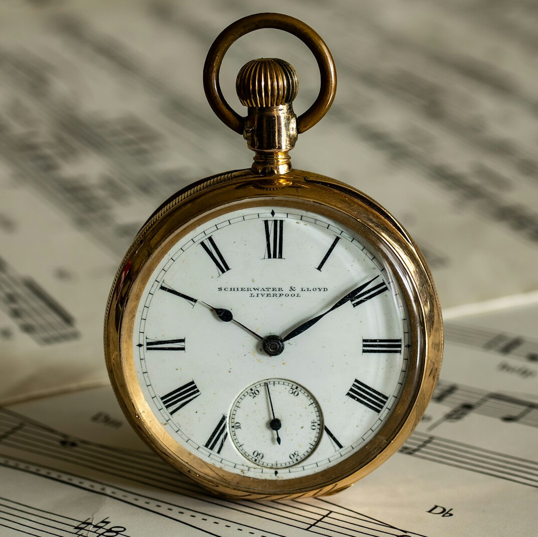 Antique pocket watch resting on old papers