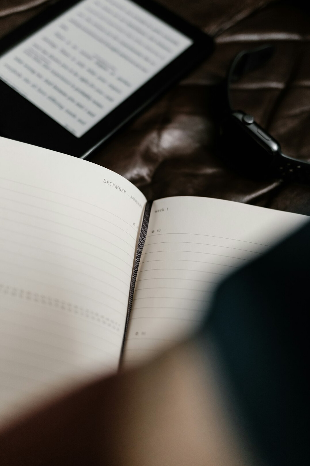 Magnifying glass resting on an open notebook with handwritten notes