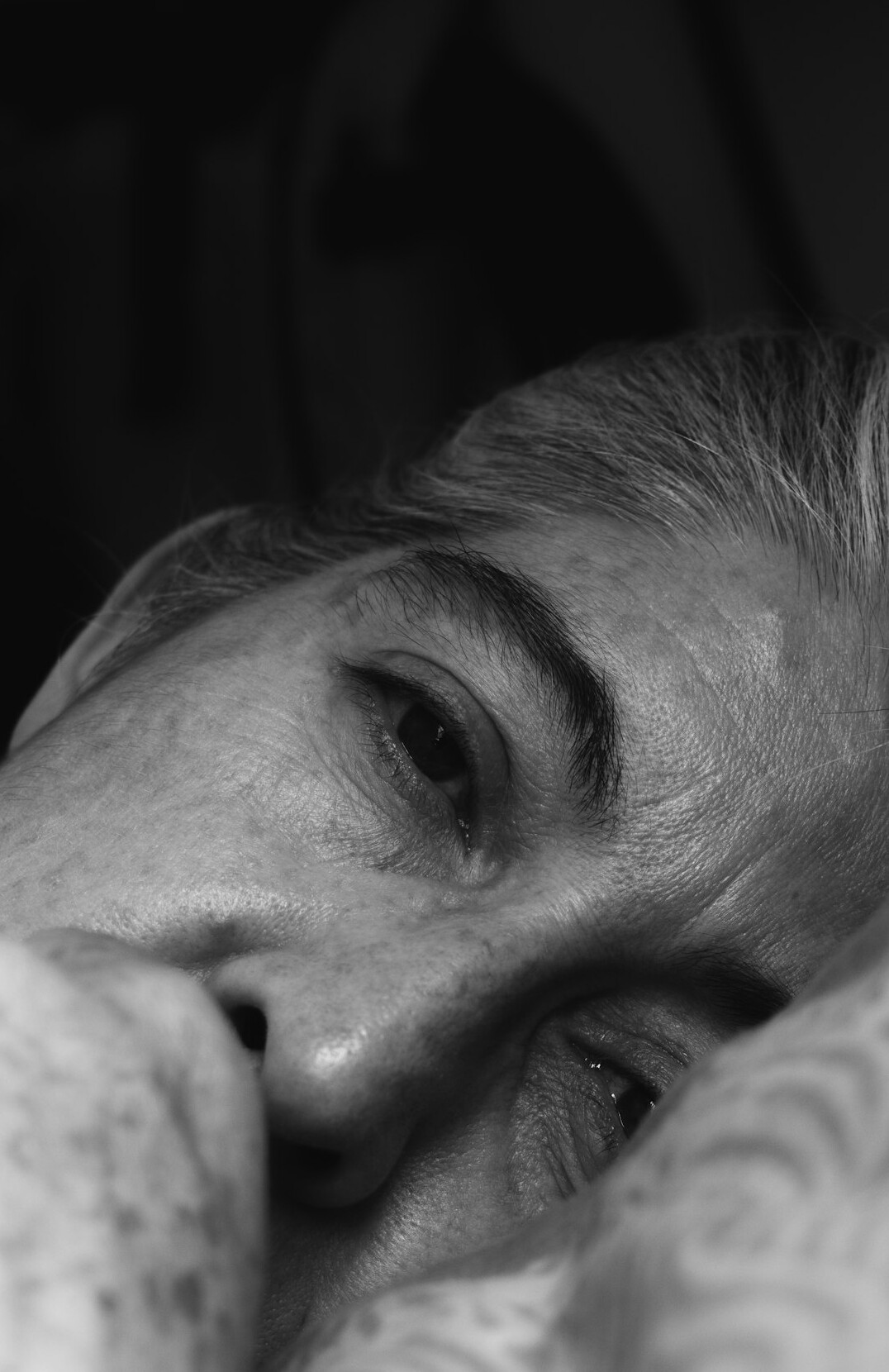 Studio portrait of an older Hispanic man with grey hair